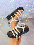 White black slingback platform sandals detail view with parallel straps and ankle buckle