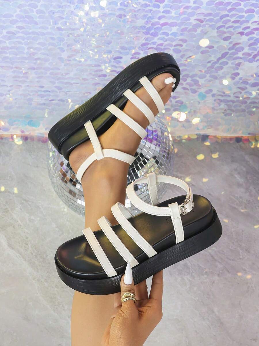 White black slingback platform sandals detail view with parallel straps and ankle buckle