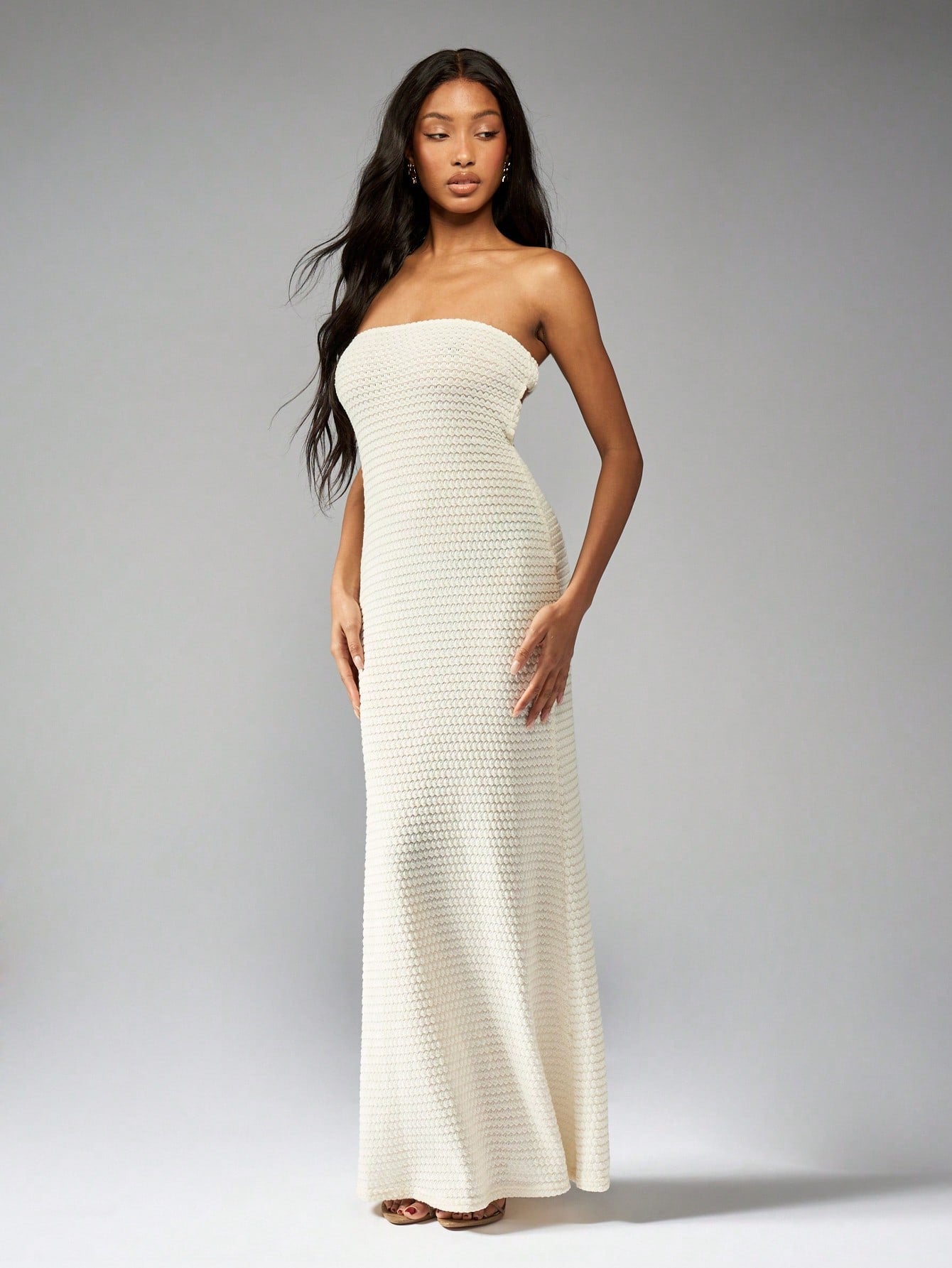 Step into summer with this Crochet Knit Bandeau Maxi Dress. Featuring intricate bead detailing, a playful cut-out back, and a flowy flared hem, this dress will have you turning heads at any event. Show off your unique style and stay cool in this must-have piece.