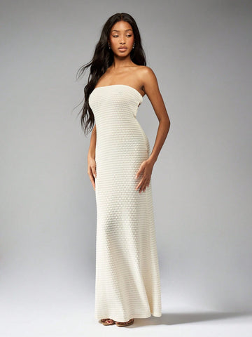 Step into summer with this Crochet Knit Bandeau Maxi Dress. Featuring intricate bead detailing, a playful cut-out back, and a flowy flared hem, this dress will have you turning heads at any event. Show off your unique style and stay cool in this must-have piece.
