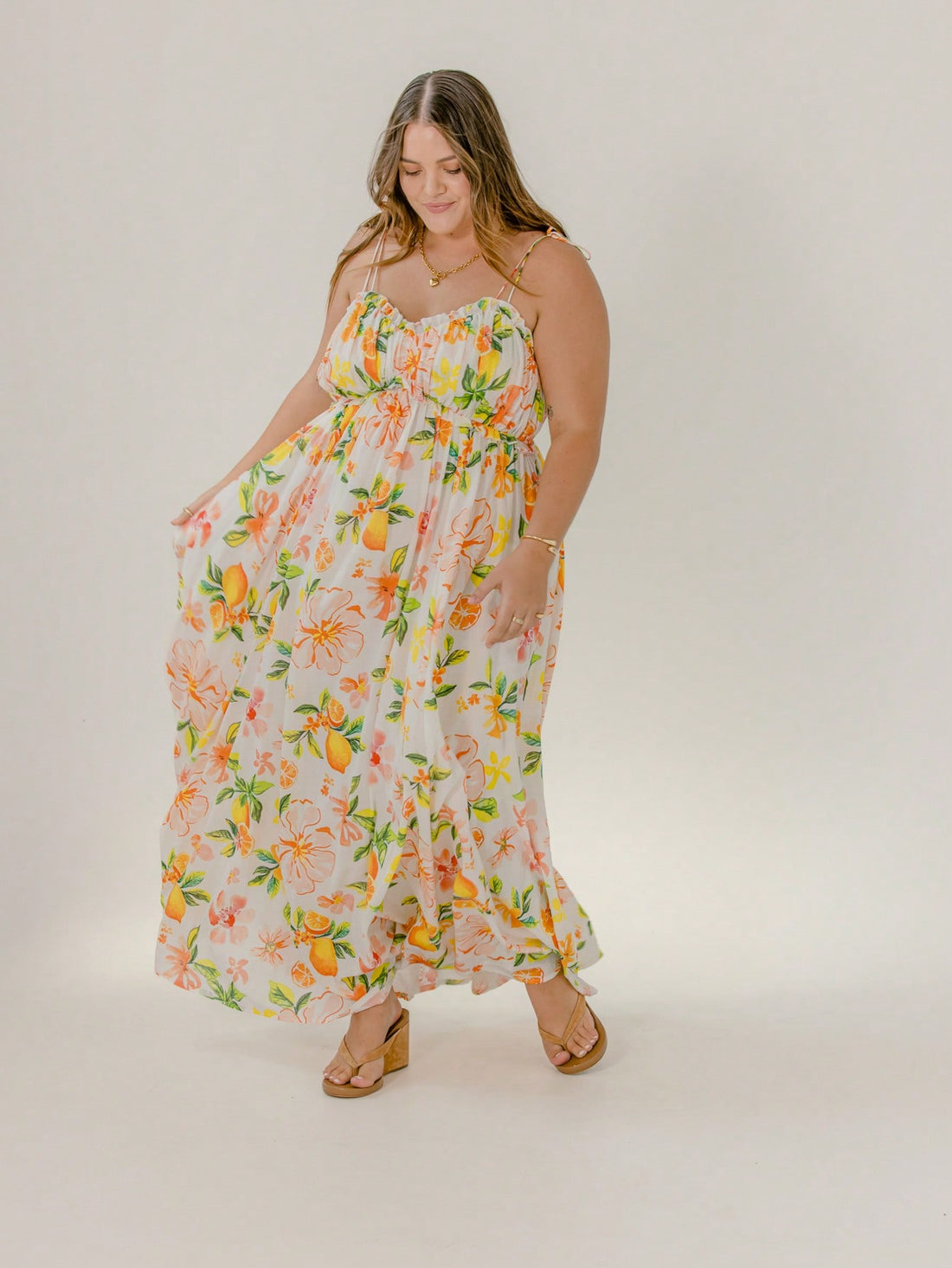 Step into sunshine and ease with the Curve Floral Tie Strap Smocked Maxi Dress. Its playful floral pattern and adjustable tie straps bring flirtatious charm, while the smocked bodice offers comfy stretch that flatters your curves. Perfect for beach strolls or sunset dinners, this maxi dress blends carefree style with vacation-ready vibes.
