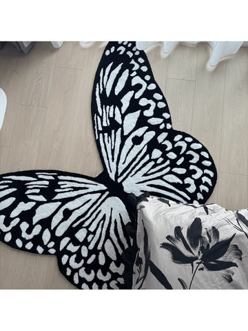 Add a touch of whimsy to any room with this adorable black and white butterfly velvet rug. Soft to the touch and featuring a non-slip backing, it’s perfect for brightening up your home or office while keeping you safe from slips. Let these charming butterflies flutter underfoot and bring playful style wherever you place it!