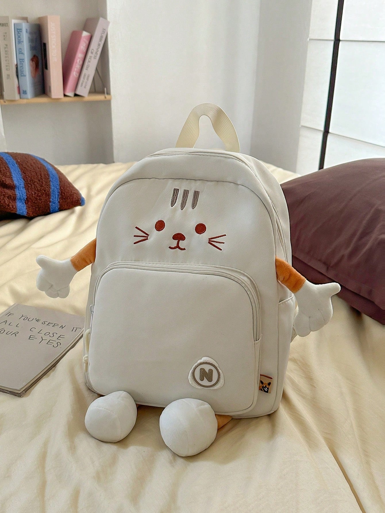 This adorable white nylon backpack features a charming cartoon cat embroidery, making it a fun and stylish choice for school or casual outings. Lightweight and equipped with a smooth zipper, it’s perfect for carrying your essentials with ease. Its playful anime-inspired design makes it an ideal gift for back-to-school or graduation celebrations. Add a touch of whimsy to your day with this cute and practical backpack!
