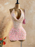 Turn heads in this stunning sequin mini dress designed for unforgettable nights out. Featuring a bold metal draped halter neckline and daring backless design, this bodycon silhouette hugs your curves perfectly while the tie-back detail adds an elegant touch. The shimmering sequin fabric catches the light beautifully, making it ideal for parties and summer getaways. Lined for comfort and crafted from a stretchy polyester-elastane blend, this pink beauty offers both style and wearability. Hand wash to maintai