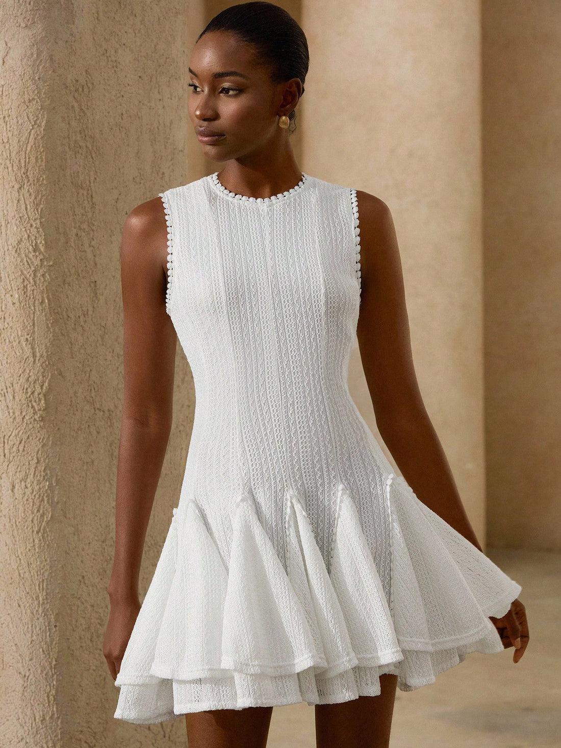 Step into summer with this playful white floral crochet sleeveless dress. Its delicate crochet pattern adds a touch of elegance while keeping you cool and comfortable. Perfect for sunny days and warm evenings, this versatile dress effortlessly blends charm and style for any occasion.