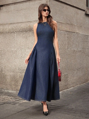 Full front view of dark-indigo sleeveless denim maxi dress with fitted bodice and flared skirt
