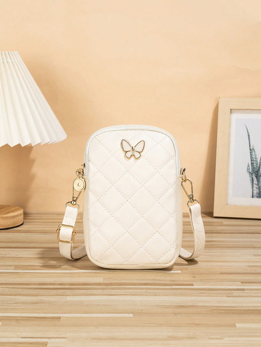 This elegant crossbody phone bag for women features a diamond grid design and beautiful bowknot embroidery. Keep your phone safe and stylish while on-the-go. With its versatile crossbody strap, you can stay hands-free and organized. A must-have accessory for any fashion-forward woman.