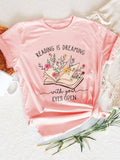 This comfy tee is perfect for book lovers and librarians alike! With a playful design featuring funky fonts and eye-catchy illustrations, it's a must-have for any bookworm's wardrobe. Made with soft fabric, it's perfect for lounging with your favorite read. Don't judge a book by its cover, but definitely grab this tee!