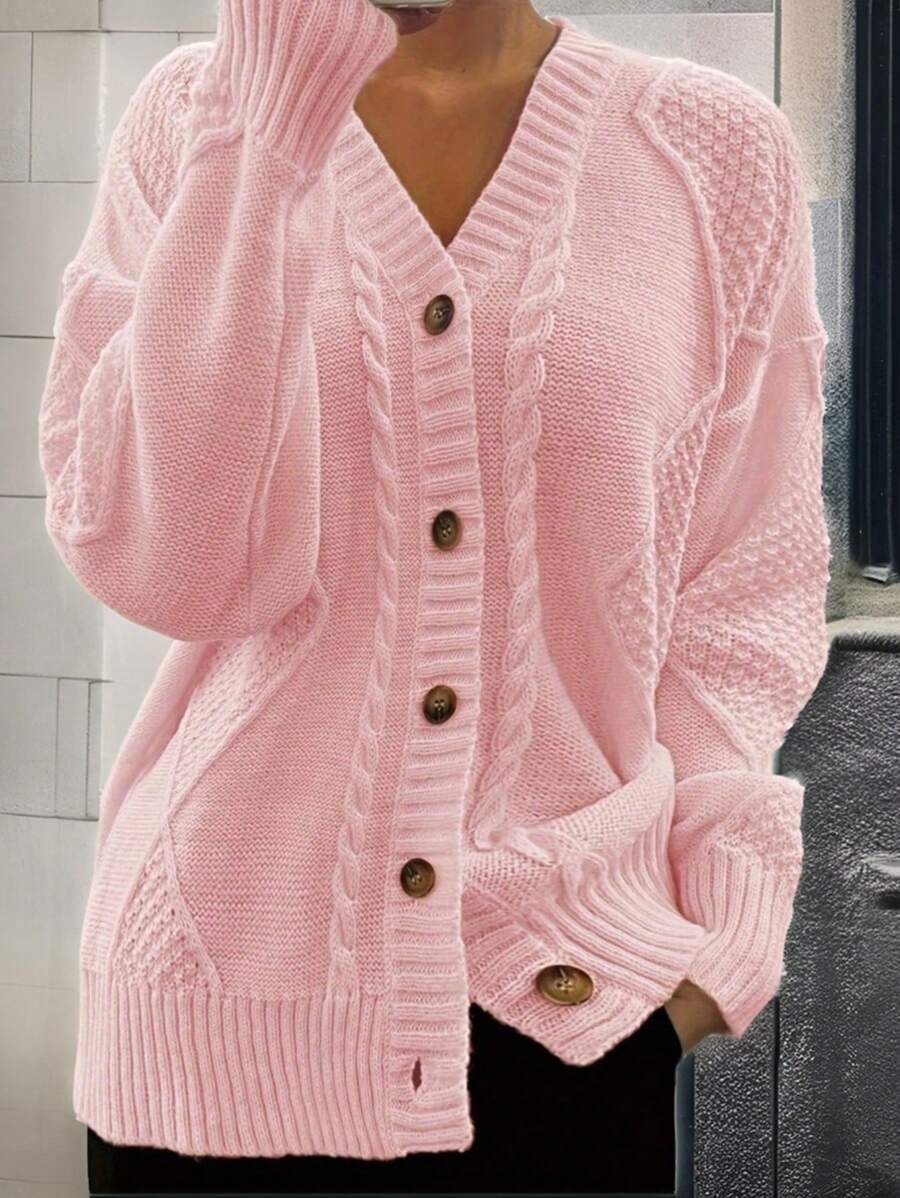 Front view of pastel pink cable-knit cardigan with drop shoulders and buttons for casual styling