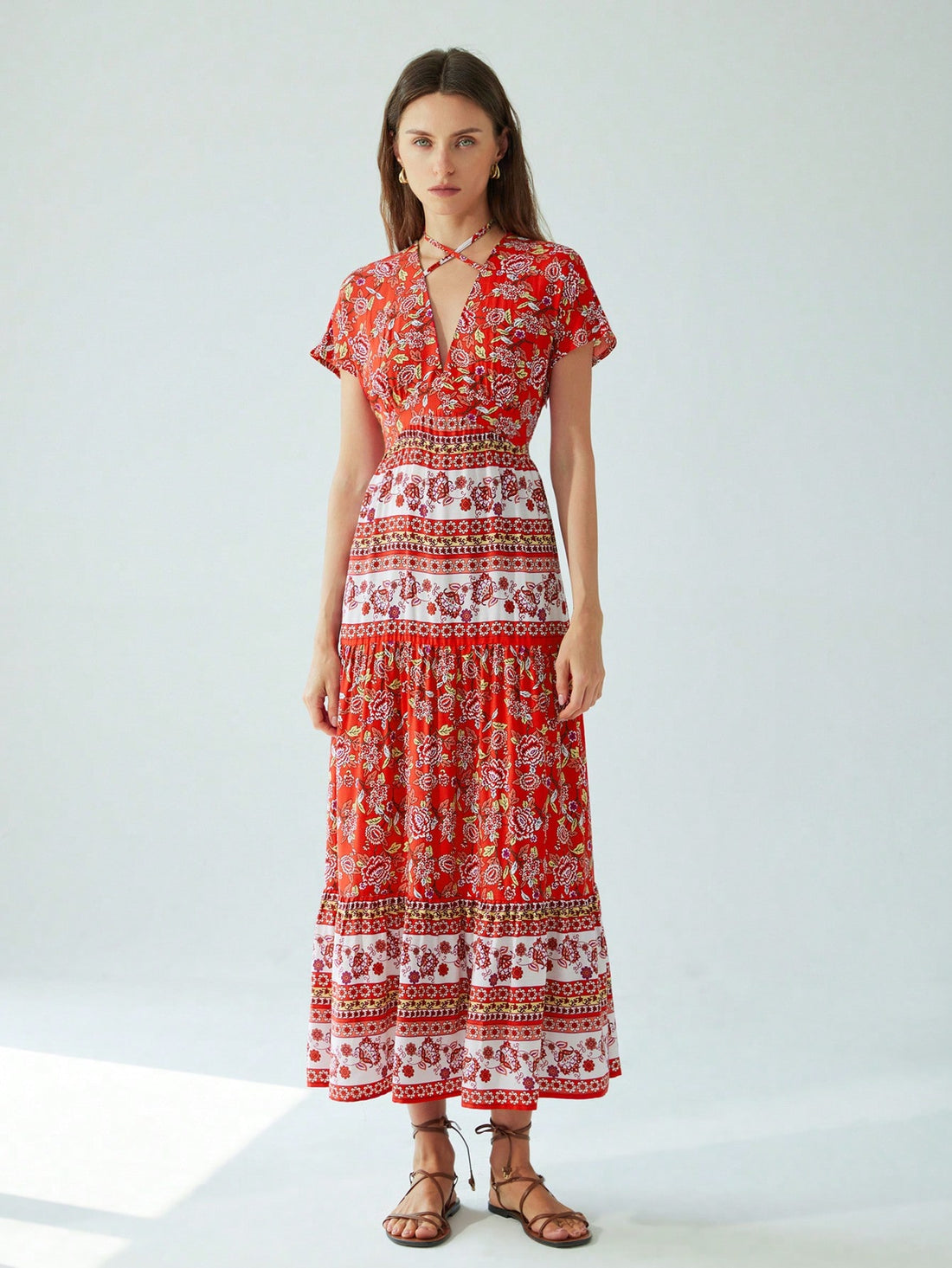 Step into summer with this playful Easy-Wear Print Maxi, featuring a flirty V-neck and a chic halter neck patchwork design. Perfect for breezy days and resort getaways, it combines comfort and style effortlessly. Whether you're strolling the beach or enjoying a sunset cocktail, this maxi dress keeps you cool and radiant all day long.
