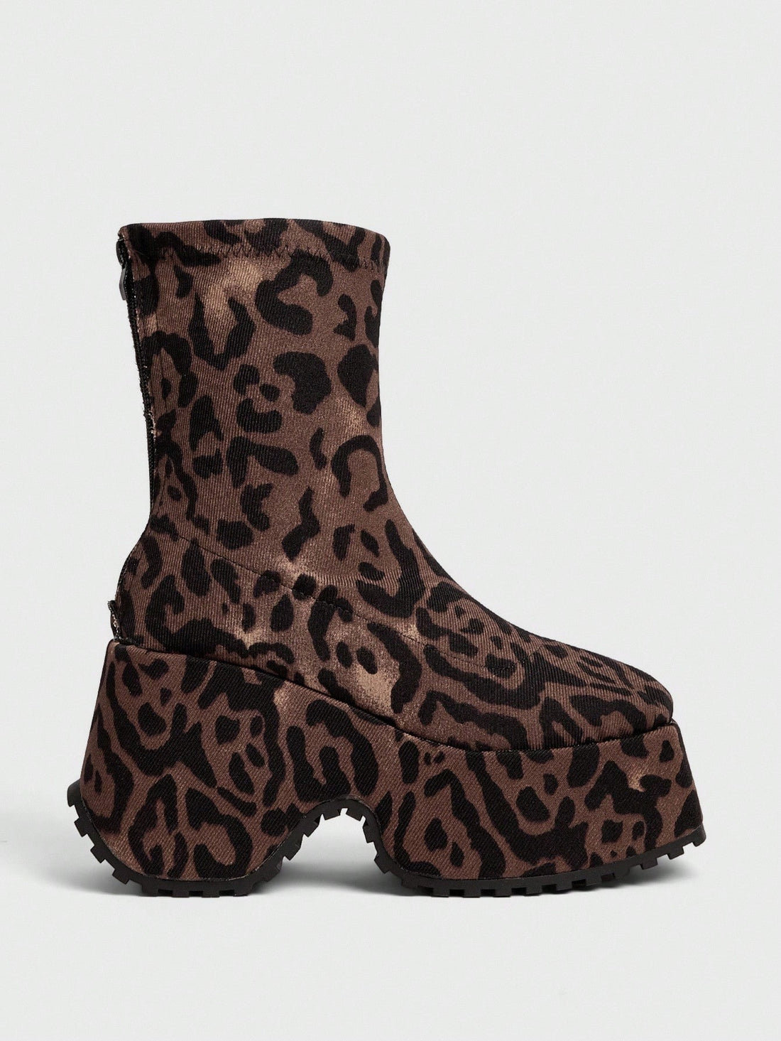 Step into the future with these bold Y2K platform boots that scream attitude. Featuring a chunky sole and asymmetric heel design, these black punk-inspired ankle boots deliver maximum edge with every stride. Perfect for channeling your inner goth aesthetic or adding rebellious flair to any outfit. Whether you're hitting the club or making a statement on the street, these boots command attention and refuse to blend in. Unapologetically bold, undeniably cool.