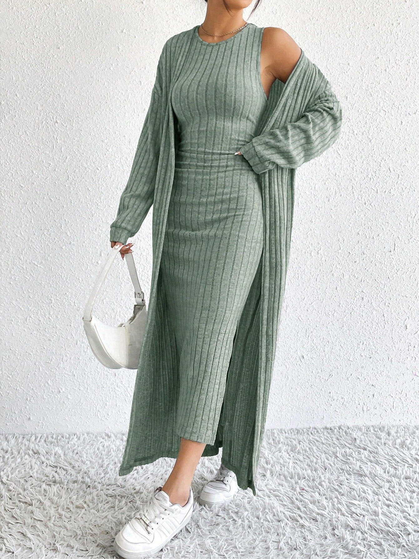 Effortless Elegance with this minimalist knit set. The sleeveless dress provides a chic and breezy look, while the long sleeve cardigan adds a touch of cozy elegance. Keep it simple, yet stylish!