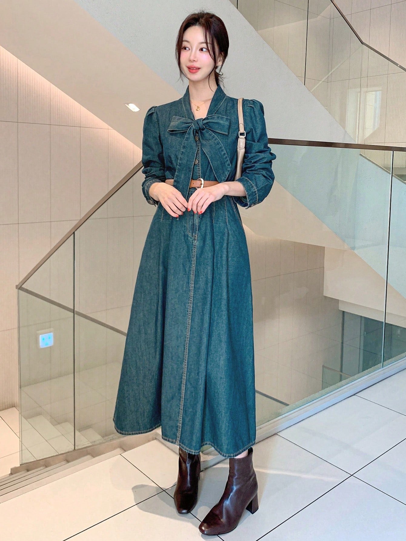 Effortlessly chic meets timeless elegance. This stunning denim dress boasts a flattering pleated design and a delicate tie-neck detail, perfect for any occasion. Expertly crafted with long sleeves and a versatile silhouette, this dress will effortlessly elevate your style and leave you feeling confident and beautiful.