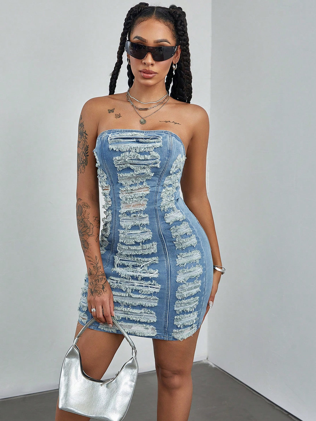 Get ready to turn heads in the Effortlessly Chic Women's Summer Patchwork Ripped Denim Tube Dress. This versatile dress combines style and comfort with its ripped denim design and tube silhouette. Perfect for any summer occasion, this dress will make you feel confident and fashionable!