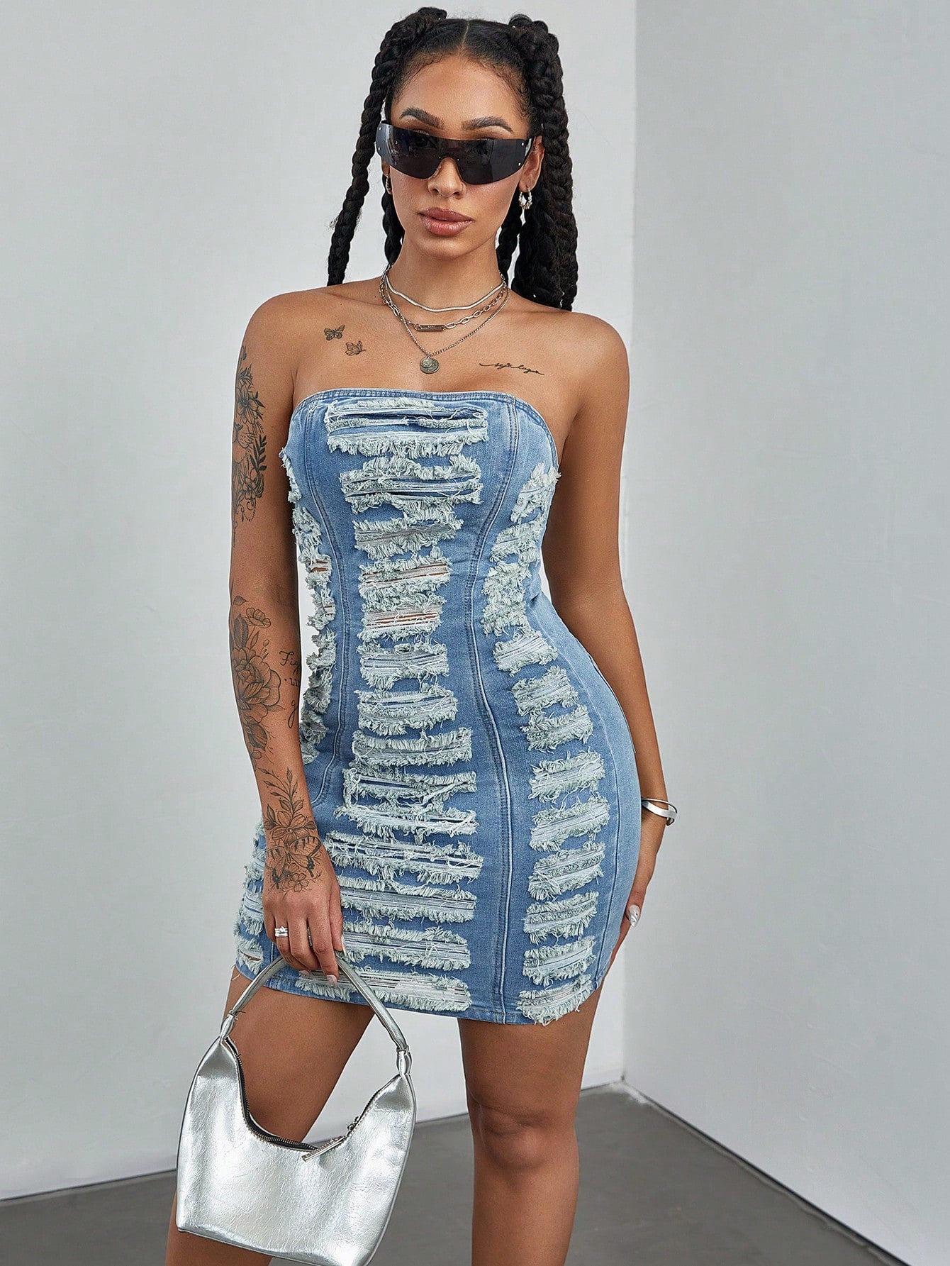 Get ready to turn heads in the Effortlessly Chic Women's Summer Patchwork Ripped Denim Tube Dress. This versatile dress combines style and comfort with its ripped denim design and tube silhouette. Perfect for any summer occasion, this dress will make you feel confident and fashionable!