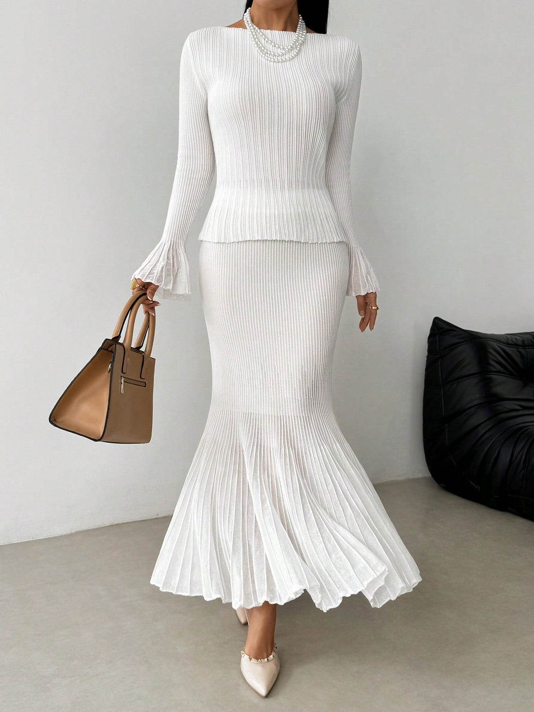 Elevate your cold-weather wardrobe with this charming two-piece set that pairs a cozy knit sweater with a gracefully pleated skirt. Perfect for layering through autumn and winter, this combo strikes the ideal balance between comfort and sophistication. The sweater's soft knit fabric keeps you warm while the skirt's structured pleats add movement and dimension to every step. Mix, match, or wear together—this versatile duo works hard to keep your seasonal style effortless and polished.