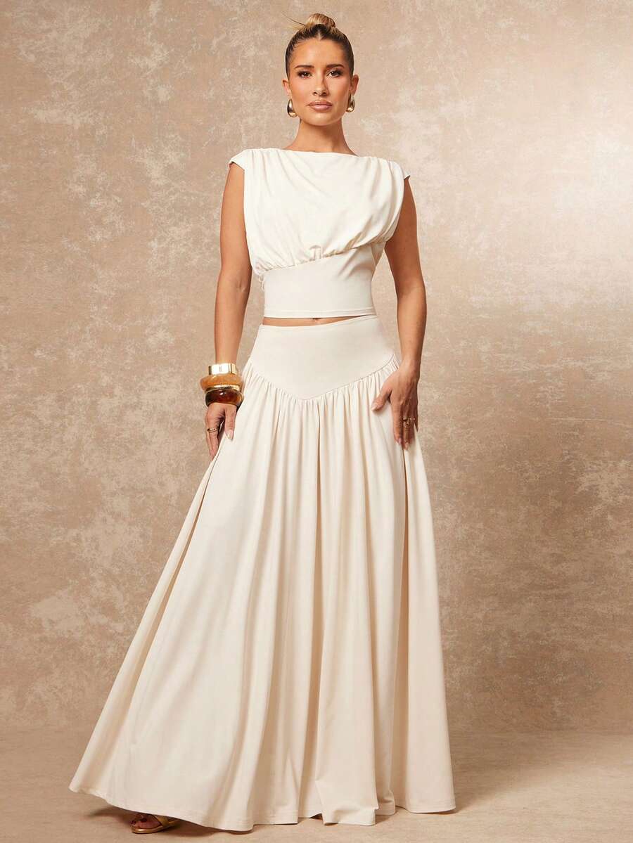 Elevate your formal wardrobe with this stunning two-piece set featuring an apricot boat neck blouse with delicate ruffle detailing and a fitted A-line skirt. The blouse showcases cap sleeves and a lined bodice crafted from a luxurious polyester-elastane blend with medium stretch for comfort and movement. The long skirt features a classic A-line silhouette that flatters every figure. Perfect for upscale parties, galas, and formal occasions, this coordinated set offers effortless elegance. The medium-stretch 