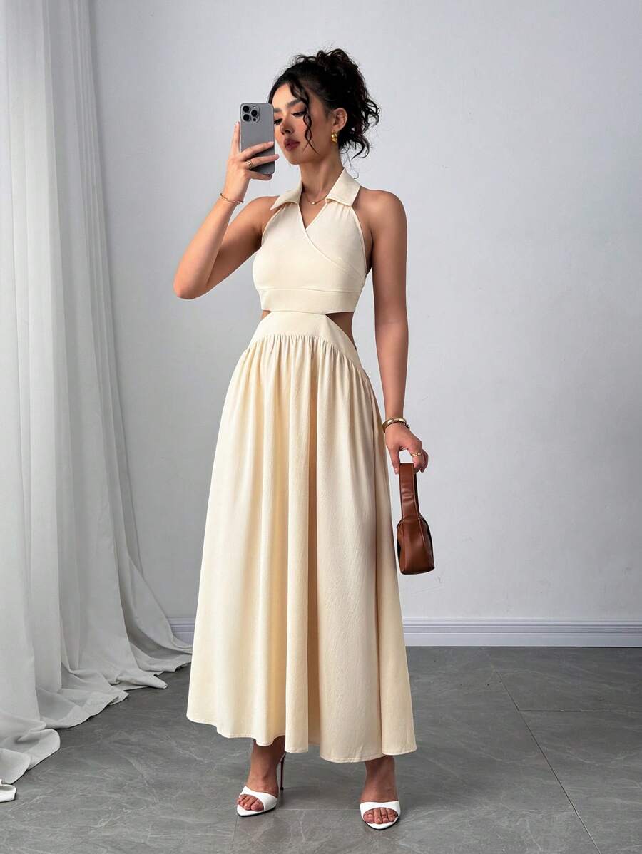 Front full-length view of apricot halter maxi dress with waist cutouts