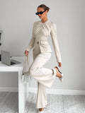 Make a statement in the office with this chic asymmetrical pleated two-piece suit that's anything but ordinary. The cream-colored ensemble features unexpected pleating that adds dimension and movement to your workday wardrobe. Perfect for commuters who refuse to sacrifice style for comfort, this suit pairs effortlessly with your favorite blouse or tee. Whether you're heading to back-to-back meetings or grabbing coffee before the day begins, this modern silhouette keeps you looking polished and feeling fabul