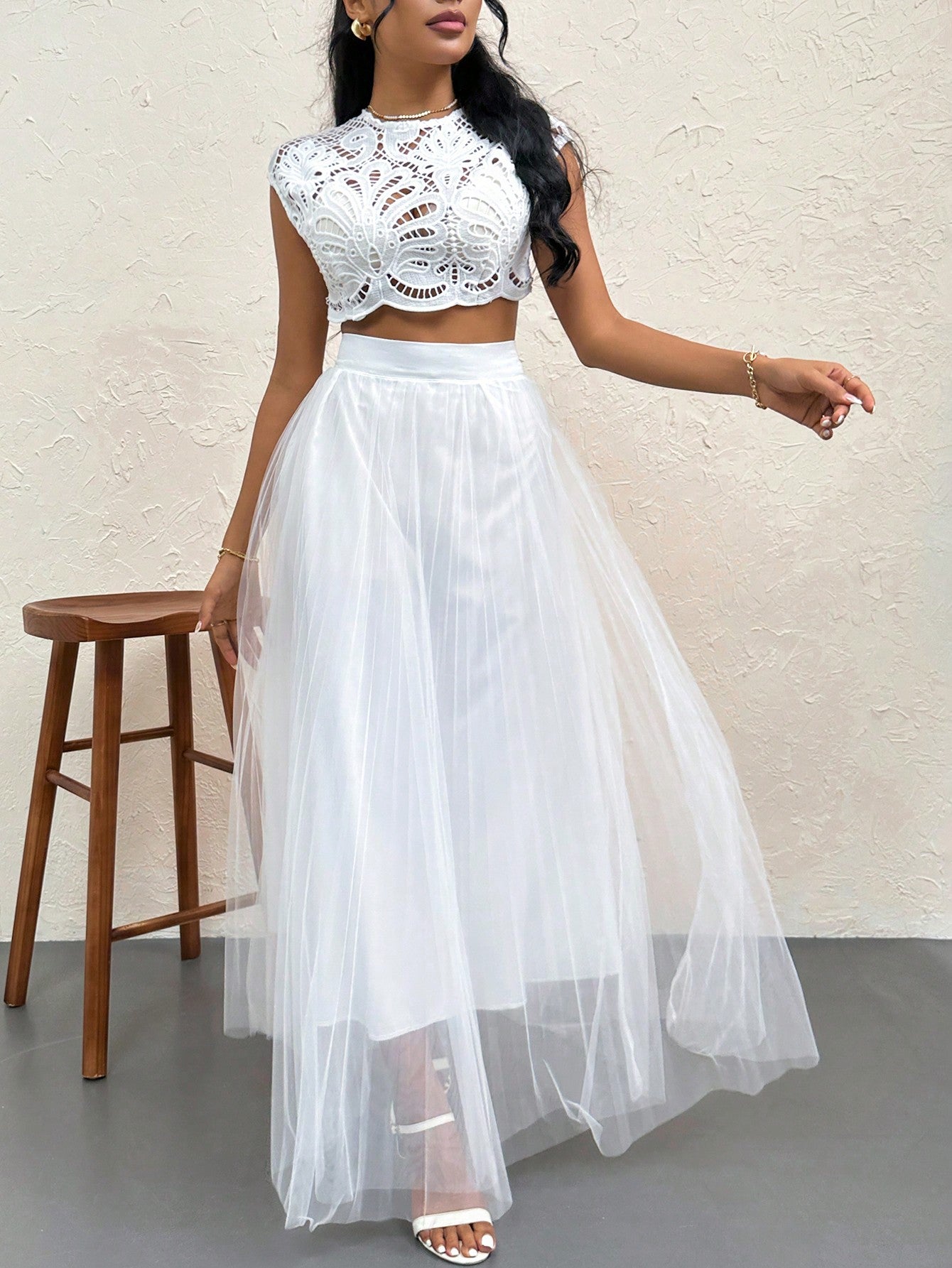 Steal the spotlight in this dreamy two-piece set that's equal parts flirty and fabulous. The delicate lace crop top features a daring backless design that lets your confidence shine, while the high-waisted skirt flatters your silhouette with timeless elegance. Perfect for romantic dinners, sunset getaways, or any moment worth remembering. This set transforms you into the main character of your own love story—because you deserve to feel absolutely stunning.