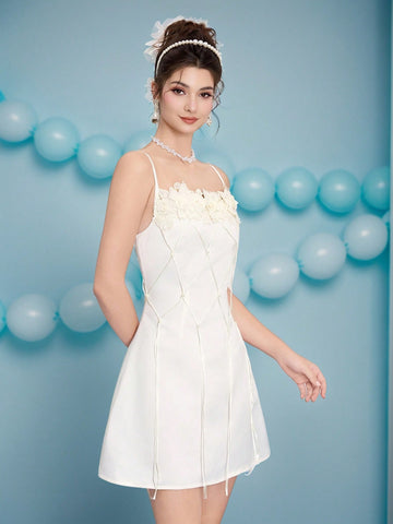 Turn heads at your next celebration in this show-stopping mini dress! Delicate spaghetti straps frame the shoulders while the daring backless design keeps things flirty and fun. Intricate 3D appliqués add dimension and texture, while playful tassels sway with every move. Perfect for parties, events, and nights when you want to feel absolutely fabulous. This dress is your ticket to making an unforgettable entrance.