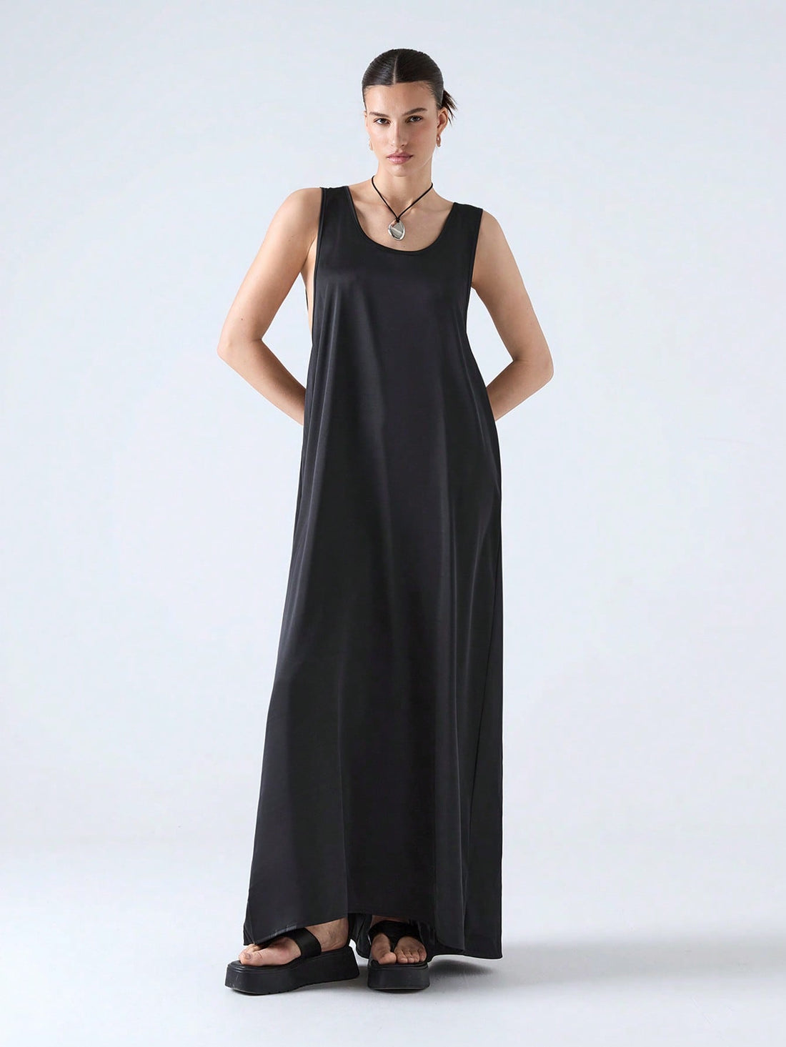 Step into the season with this playful black maxi dress featuring a chic cut-out back and a flowing ribbon that dances with every breeze. Perfect for spring and summer 2025, it combines elegance with a hint of flirtiness, making it your go-to for sunny days and warm nights.