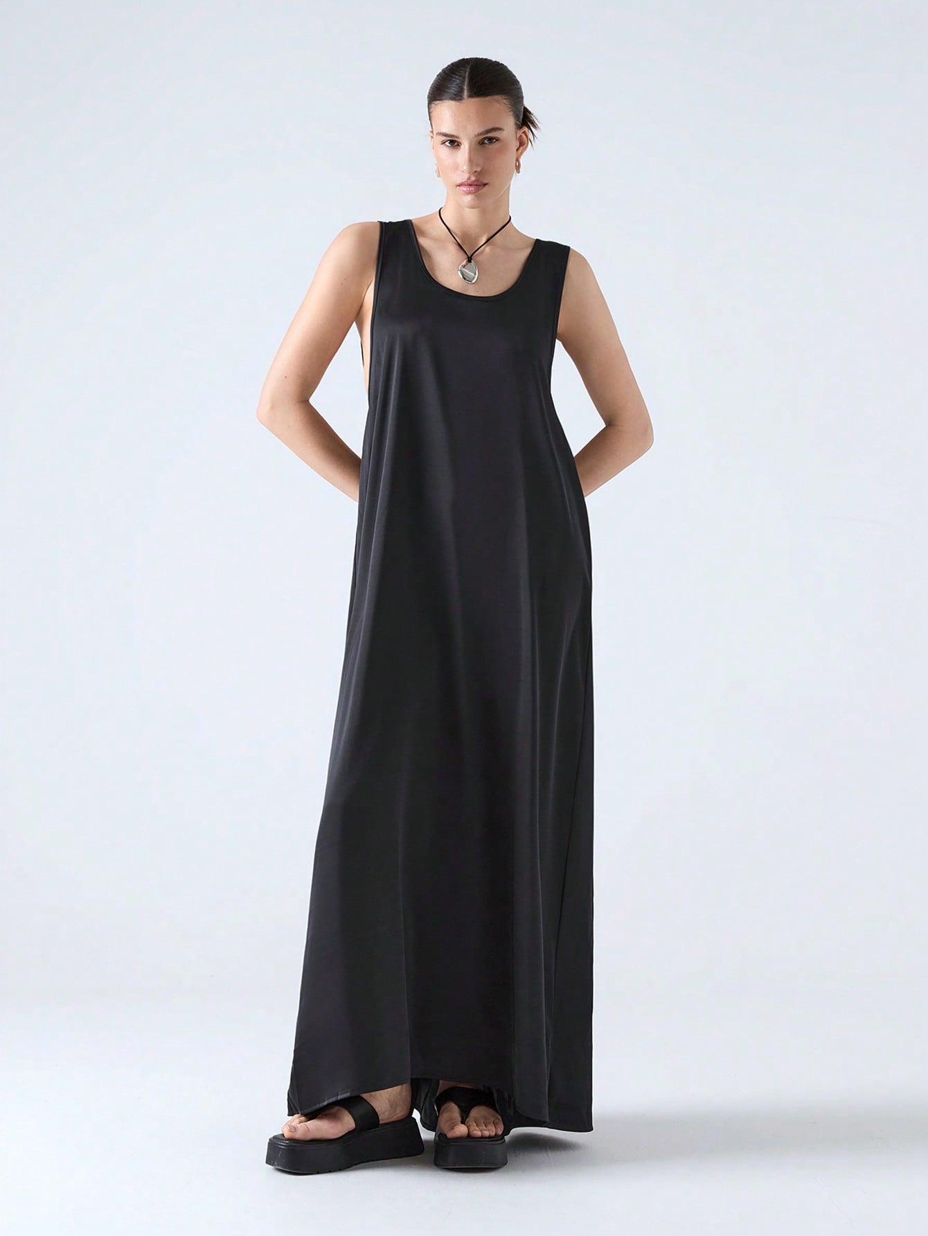 Step into the season with this playful black maxi dress featuring a chic cut-out back and a flowing ribbon that dances with every breeze. Perfect for spring and summer 2025, it combines elegance with a hint of flirtiness, making it your go-to for sunny days and warm nights.