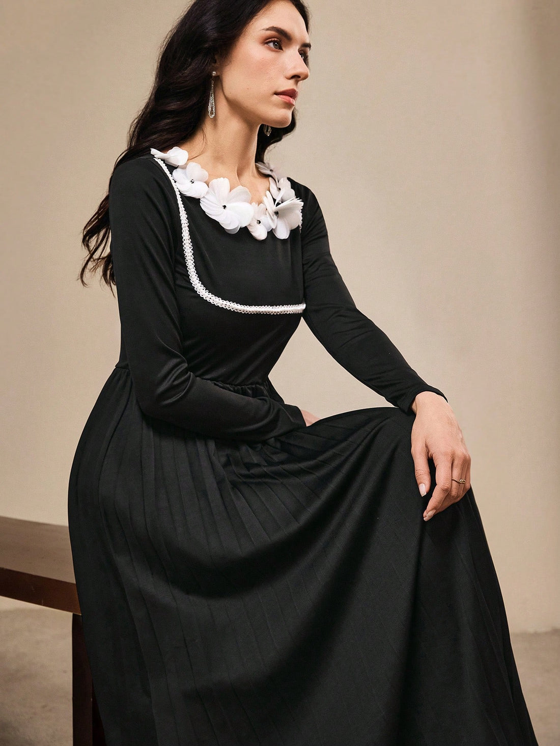 Step into the spotlight in this stunning black evening gown that's pure magic. Intricate 3D floral embellishments dance across the fabric, creating depth and dimension that catches every light in the room. The sleek silhouette flatters your figure while the dramatic length adds that red-carpet glamour you've been craving. Whether you're celebrating the holidays or marking a milestone moment, this dress transforms you into the most elegant version of yourself. It's not just an outfit—it's your ticket to feel