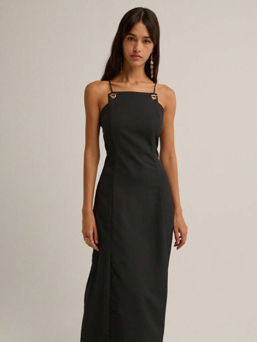 Slip into timeless elegance with this stunning black maxi dress that's equal parts sophisticated and fun. Delicate spaghetti straps frame the neckline while the show-stopping vintage crisscross back design adds an unexpected twist of allure. Perfect for fall and winter occasions, this dress transitions effortlessly from evening events to upscale casual outings. The flowing silhouette flatters every figure, making you feel confident and fabulous. Whether you're heading to a dinner date or a night out with fr