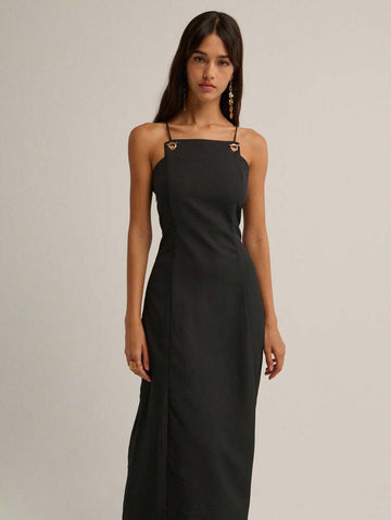 Slip into timeless elegance with this stunning black maxi dress that's equal parts sophisticated and fun. Delicate spaghetti straps frame the neckline while the show-stopping vintage crisscross back design adds an unexpected twist of allure. Perfect for fall and winter occasions, this dress transitions effortlessly from evening events to upscale casual outings. The flowing silhouette flatters every figure, making you feel confident and fabulous. Whether you're heading to a dinner date or a night out with fr