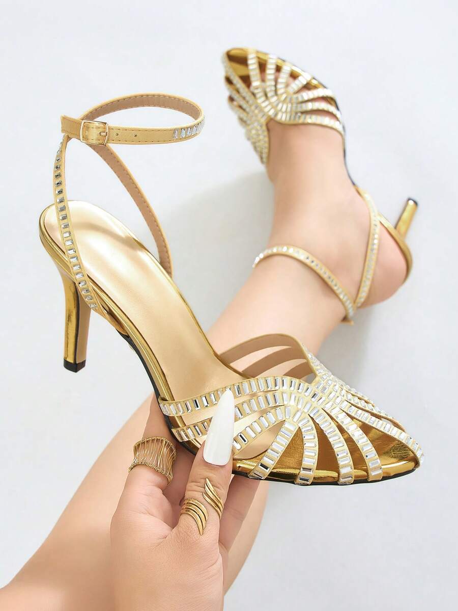 Gold open-toe stiletto sandal with curved rhinestone cage straps
