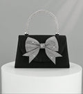 Step out in style with this Elegant Black Satin Clutch, featuring a sparkling rhinestone bowknot that adds just the right amount of glam. Perfect for parties and weddings, this luxury evening handbag is your go-to for keeping essentials close while turning heads. Its sleek design and dazzling detail make it a playful yet sophisticated accessory that brightens any outfit. Ready to dazzle? This clutch is your new best party buddy!