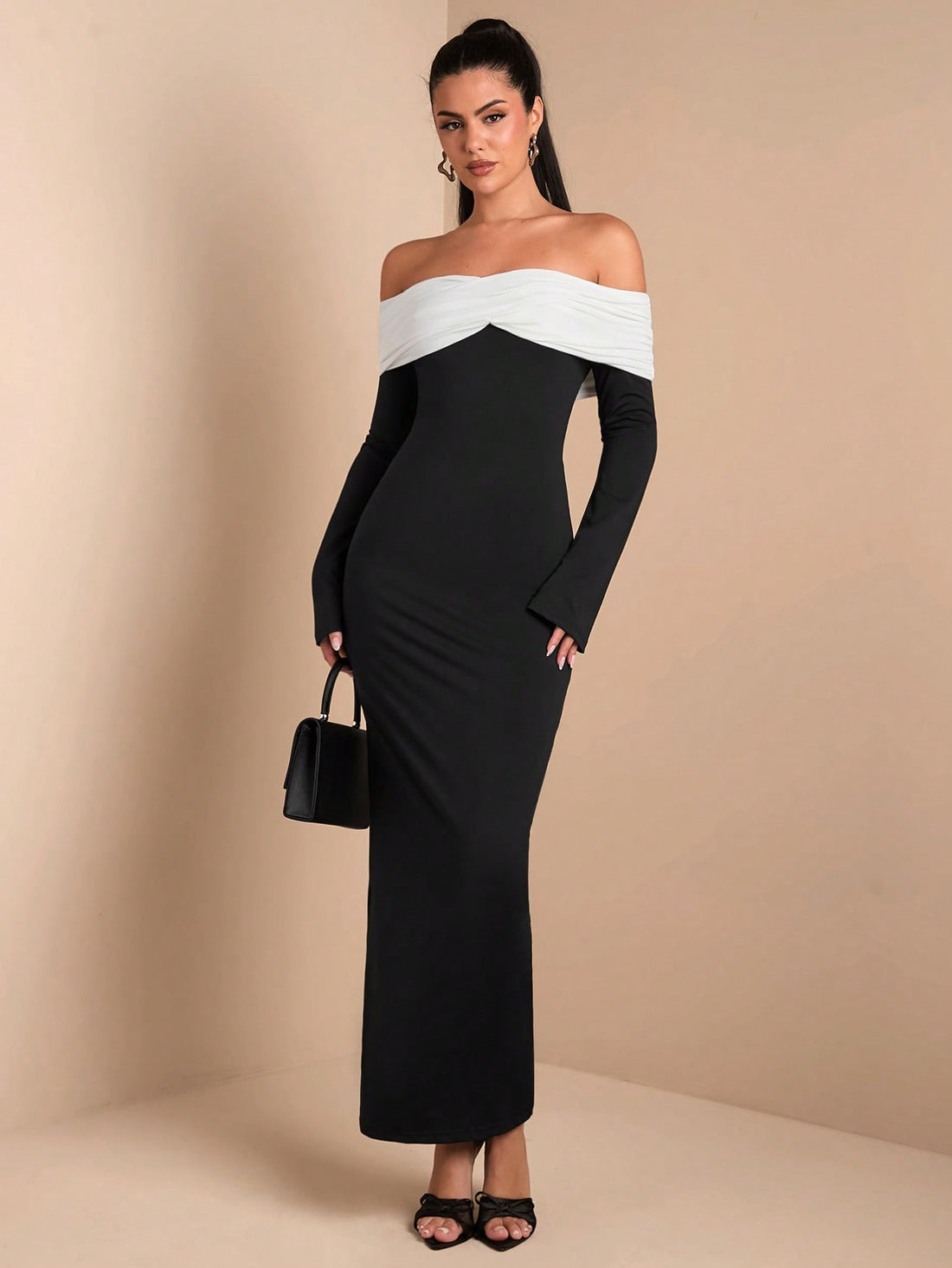Be the center of attention at any winter celebration or formal event in this elegant black and white off-shoulder bodycon dress. With its flattering design and sleek silhouette, you'll be turning heads all night long. Perfect for standing out in a sea of boring dresses.