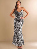 Unleash your wild side with this elegant black and white zebra print backless dress! Perfect for spring and summer vacations, its unique 3D floral ruffles add a touch of whimsy to your wardrobe. Let this dress be your statement piece and turn heads wherever you go!
