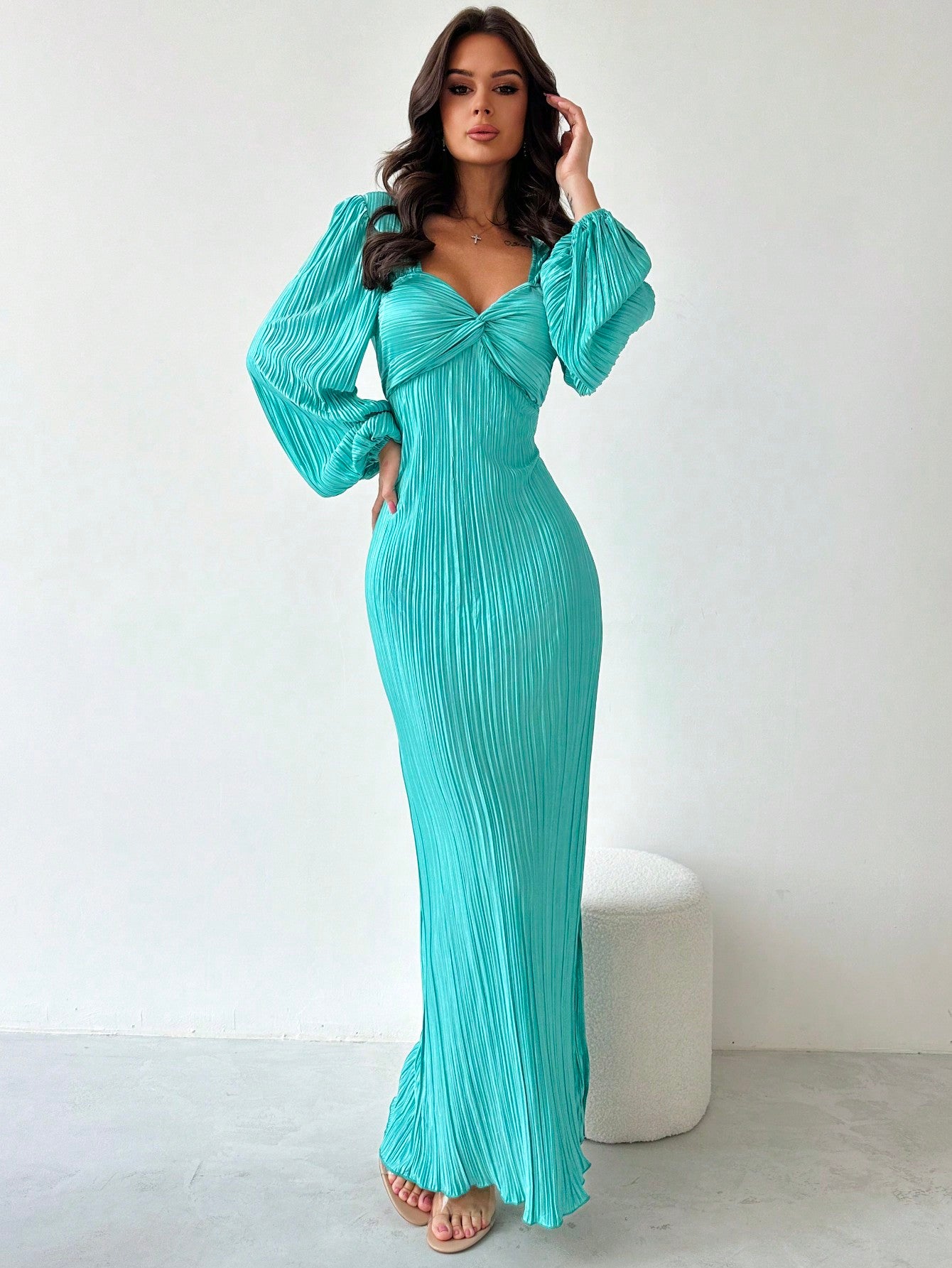 Expertly designed for autumn and winter, this elegant blue dress features a unique twist-front design and stylish puff sleeves. The pleated detailing adds a touch of sophistication, making it perfect for any occasion. Stay on-trend and comfortable with this must-have dress.