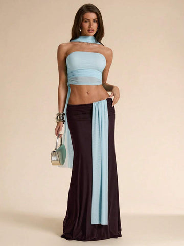 Make a statement at the beach with this elegant two-piece dress set. The asymmetric design combines a cropped top with a flowing maxi skirt in complementary blue and brown hues. The backless silhouette offers a daring, sophisticated look while remaining comfortable for all-day wear. Perfect for beach vacations, resort dinners, or tropical getaways, this set delivers effortless style and versatility for any occasion.