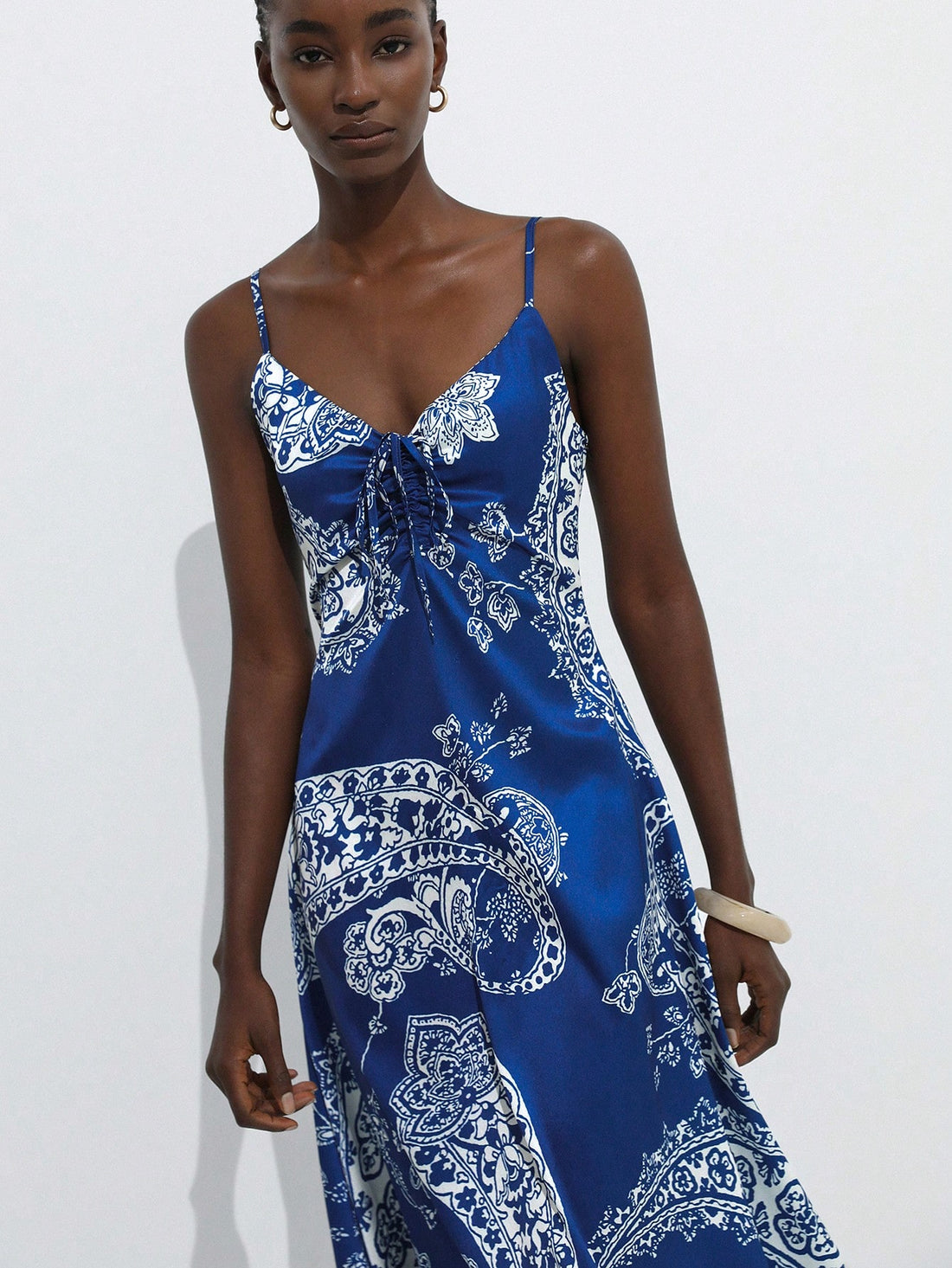 Step into sunshine with this playful blue and white summer dress, featuring delicate spaghetti straps and a charming paisley floral print. Perfect for vacation vibes, its breezy design keeps you cool while adding a splash of fun to your wardrobe. Whether strolling the beach or sipping cocktails, this dress brings effortless style and a carefree spirit to every sunny day.