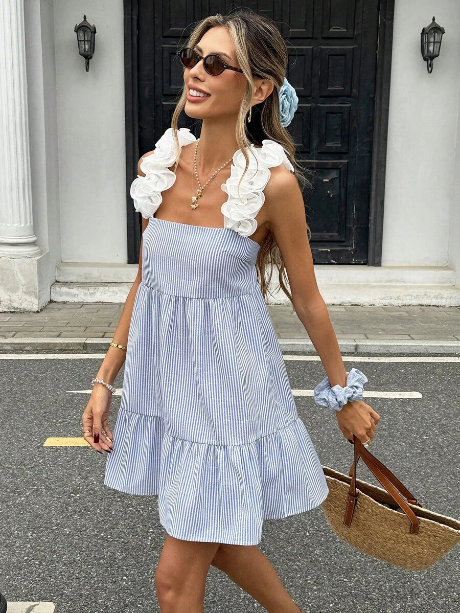 Elevate your spring and summer wardrobe with this stunning blue and white striped camisole dress. Featuring a chic square neckline, exaggerated ruffle trim, and a flattering high-waist silhouette, this mini dress effortlessly transitions from casual outings to evening events. The tie-back design adds an elegant touch, while puff sleeves provide a playful, feminine flair.
