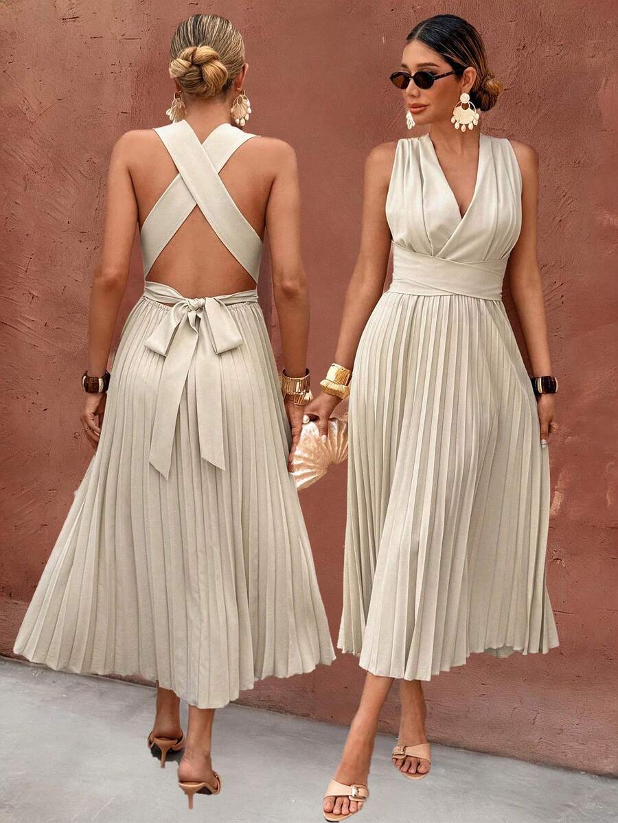 Front view of apricot sleeveless pleated midi dress with wrap V-neck and high waist