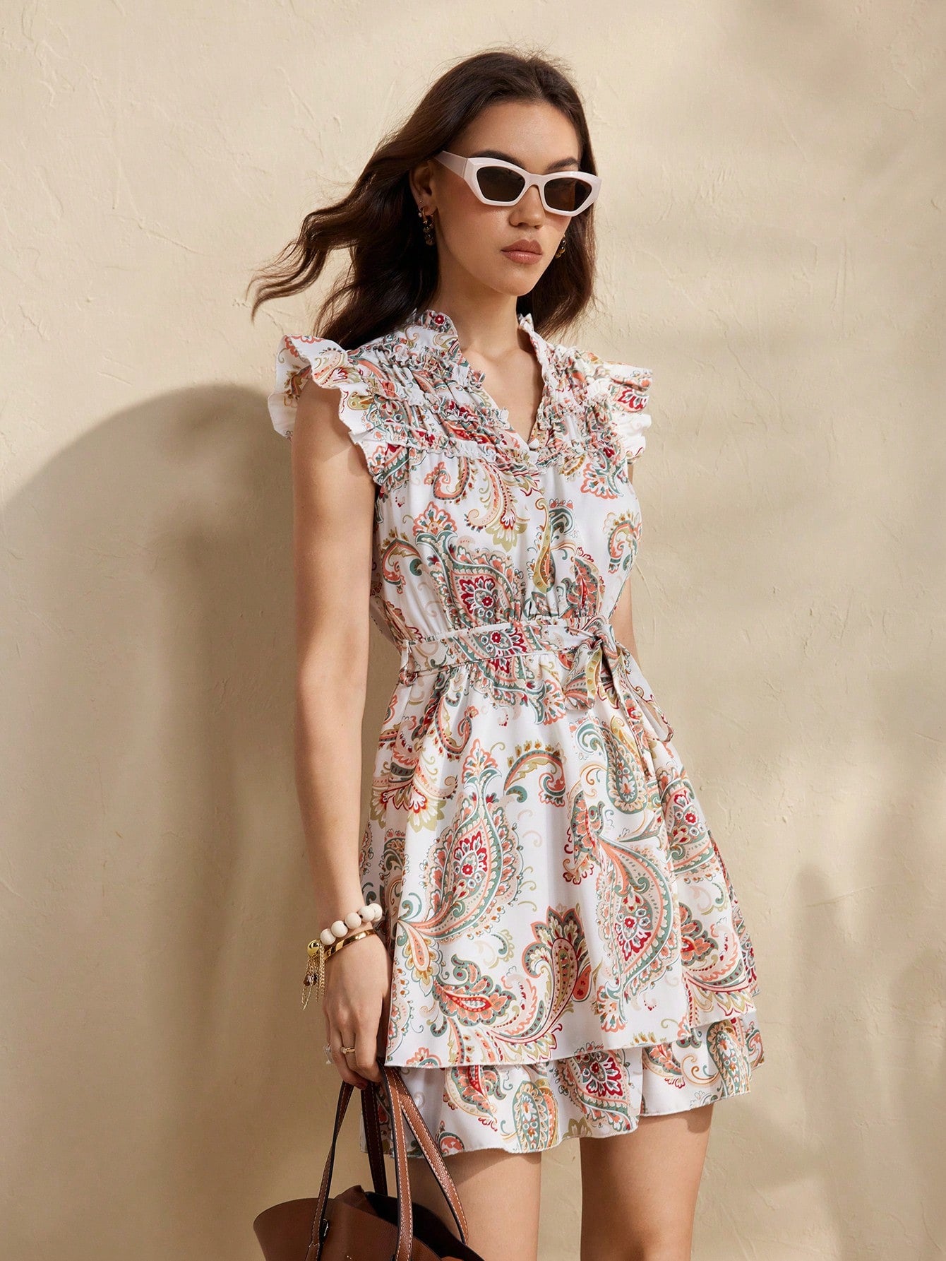 Embrace your free spirit in this whimsical bohemian dress! With playful cap sleeves, a flattering tie-up waist, and a flirty ruffled hem, you'll be turning heads wherever your adventures take you. The eye-catching print adds just the right amount of fun to your vacation wardrobe – because life's too short for boring clothes!