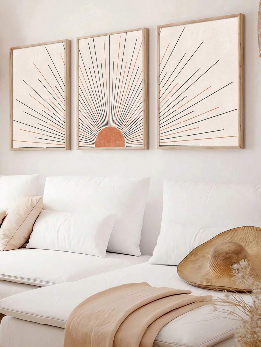 Angled living room mockup of three apricot sunrise prints in light wood display frames