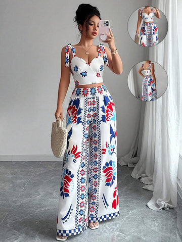 Embrace your free-spirited side with this stunning bohemian two-piece set! The delicate bowknot cami crop top pairs perfectly with flowing wide-leg printed pants, creating an effortlessly chic look that's ready for any summer adventure. Whether you're dancing at festivals, exploring new places, or simply soaking up the season, this set delivers boho vibes with a playful twist. The lightweight fabrics keep you cool and comfortable while the eye-catching prints and feminine details turn heads. Perfect for cre