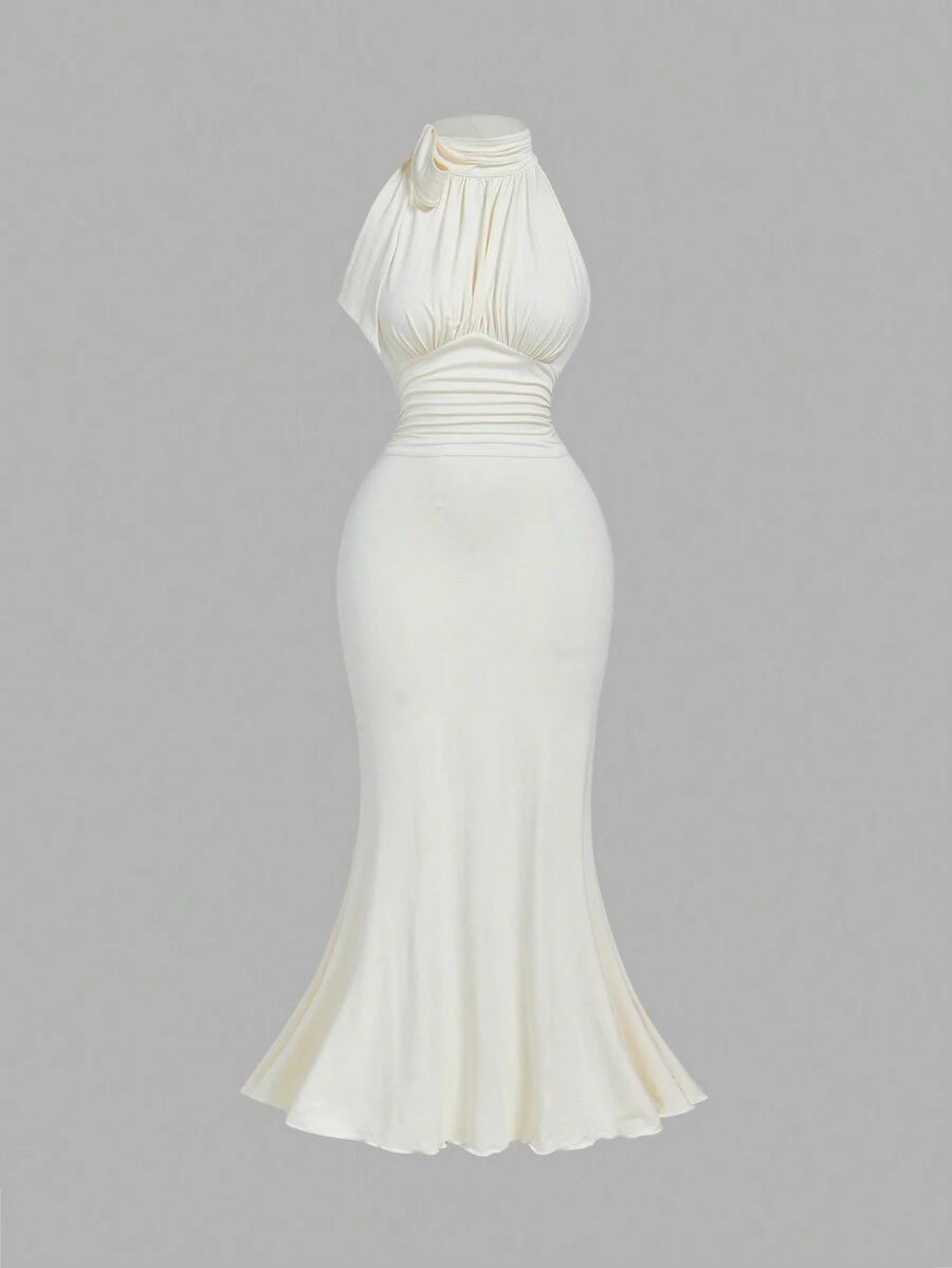 Turn heads in this Elegant Bowknot Neck Ruched Bodycon Dress with a flirty mermaid hem. The charming bowknot neckline adds a hint of whimsy,