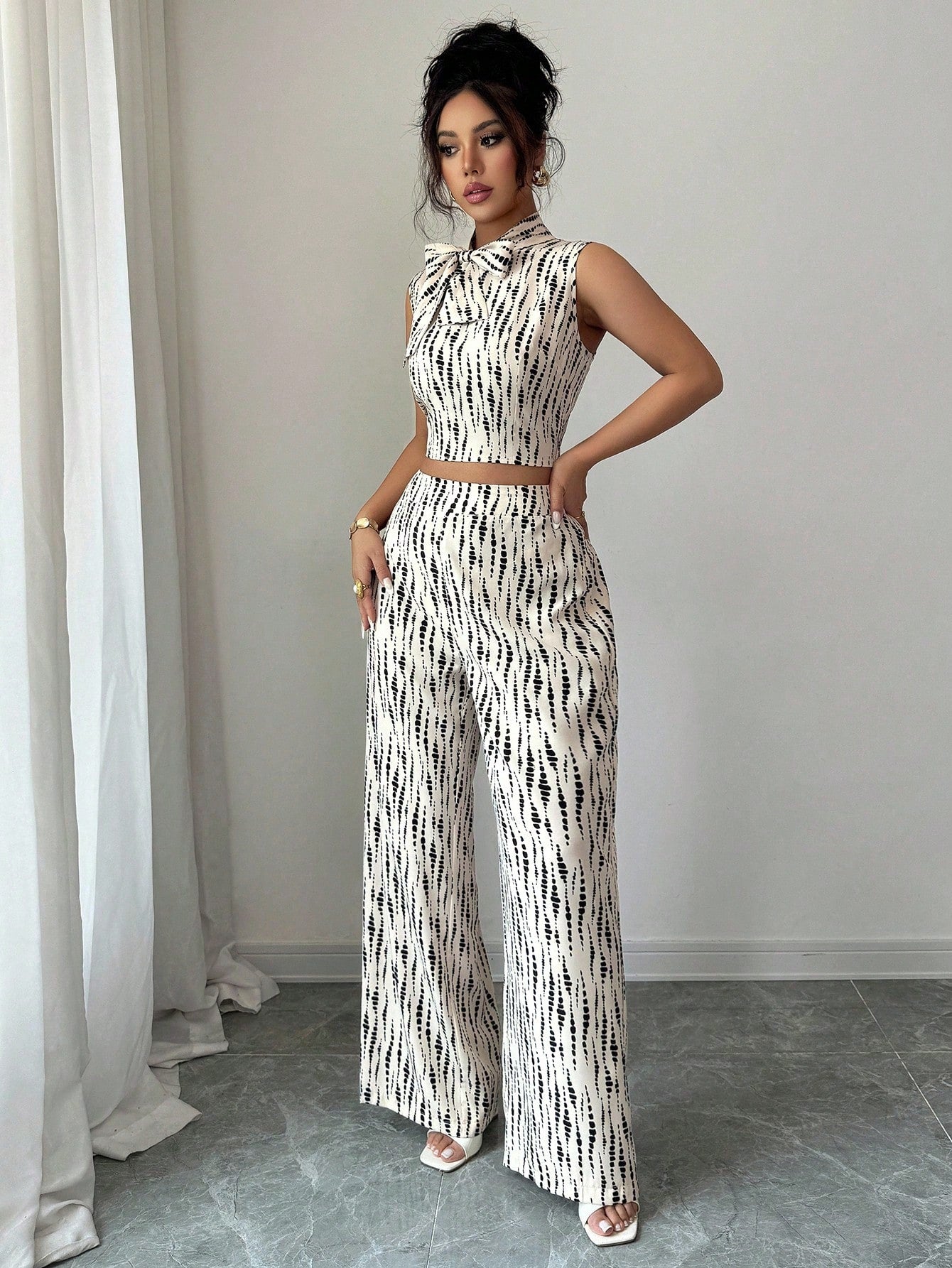 Elevate your everyday wardrobe with this charming two-piece set that effortlessly blends sophistication and comfort. The standout bowknot neckline adds a touch of feminine elegance, while the relaxed-fit pants keep you feeling at ease all day long. Perfect for casual outings, weekend brunches, or laid-back office vibes, this set proves you don't have to choose between style and comfort. Mix, match, or wear together—this versatile duo is your new go-to for looking polished without the fuss.