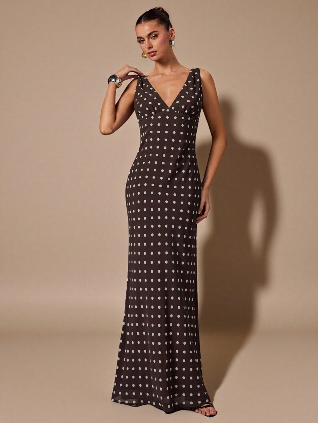 Turn heads this season in our stunning brown polka dot mermaid hem dress. The daring deep V neckline and sleeveless silhouette create an effortlessly sexy vibe, while the flowing chiffon fabric keeps you cool and comfortable. The playful polka dot pattern adds vintage charm, and the dramatic mermaid hem gives you that show-stopping moment when you move. Perfect for spring and summer occasions where you want to feel confident and fabulous.