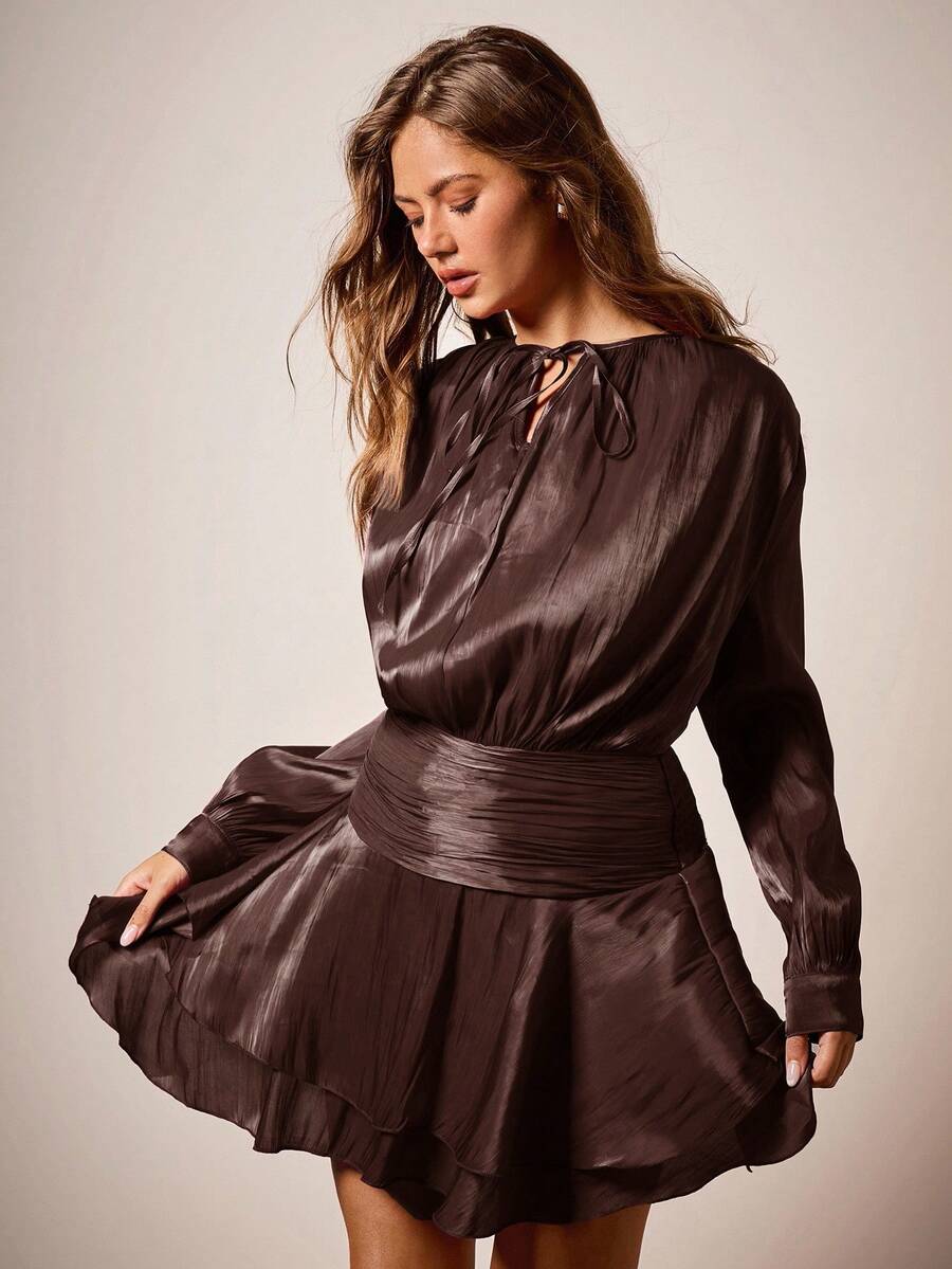 Raise a glass to holiday glamour in this stunning burgundy dress that's equal parts sophisticated and fun. The charming tie collar adds a flirty touch, while the playful ruffle hem keeps things festive without taking itself too seriously. Perfect for Christmas parties, family gatherings, or anywhere you want to make a merry entrance. Slip into elegance and let the season's spirit shine through your style.
