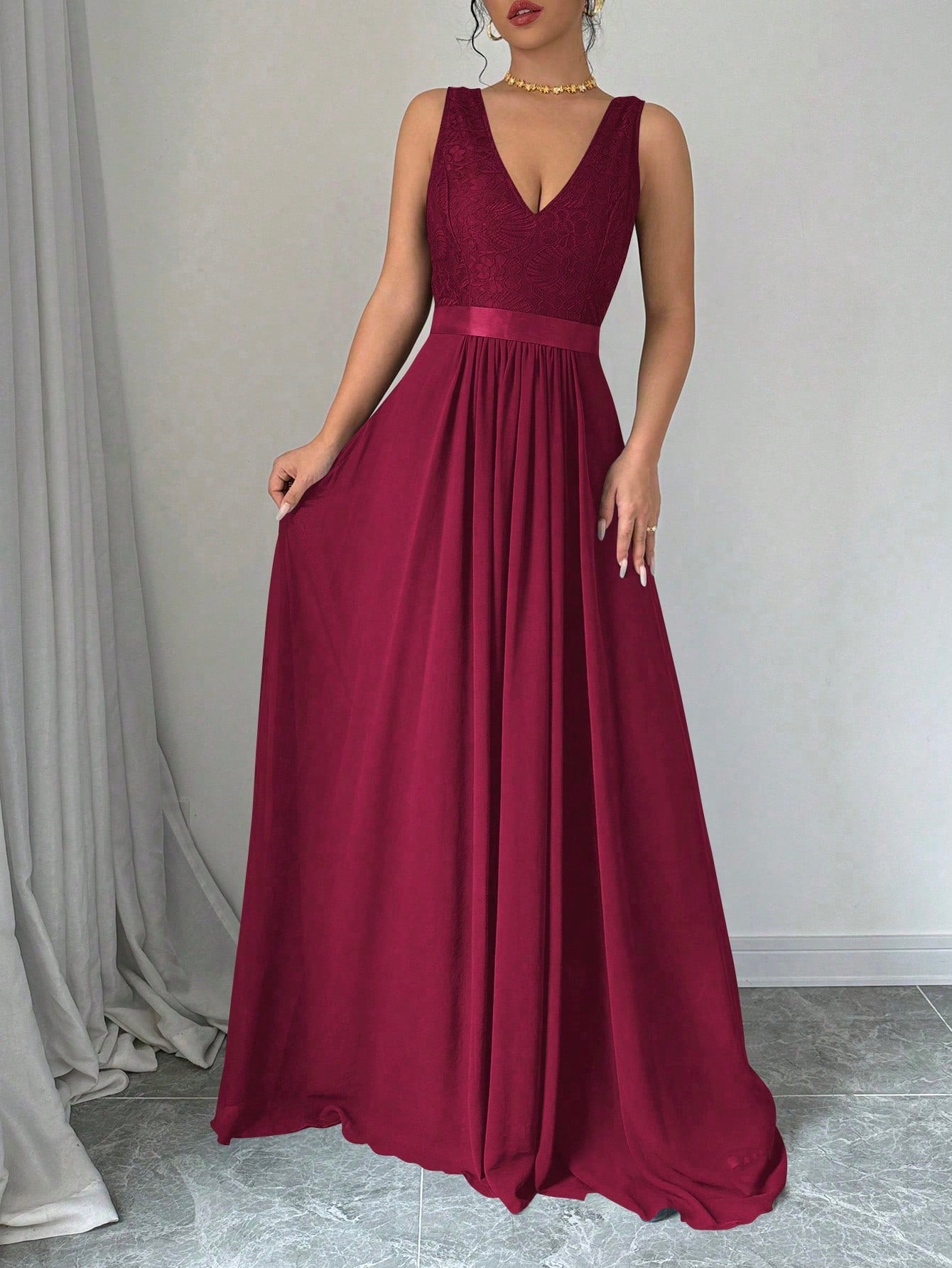This stunning burgundy maxi dress features a flattering v-neck and elegant pleating, making it the perfect outfit for any occasion. Look stylish and feel comfortable all day with this sleeveless dress. Stand out from the crowd in this uniquely chic and versatile piece.