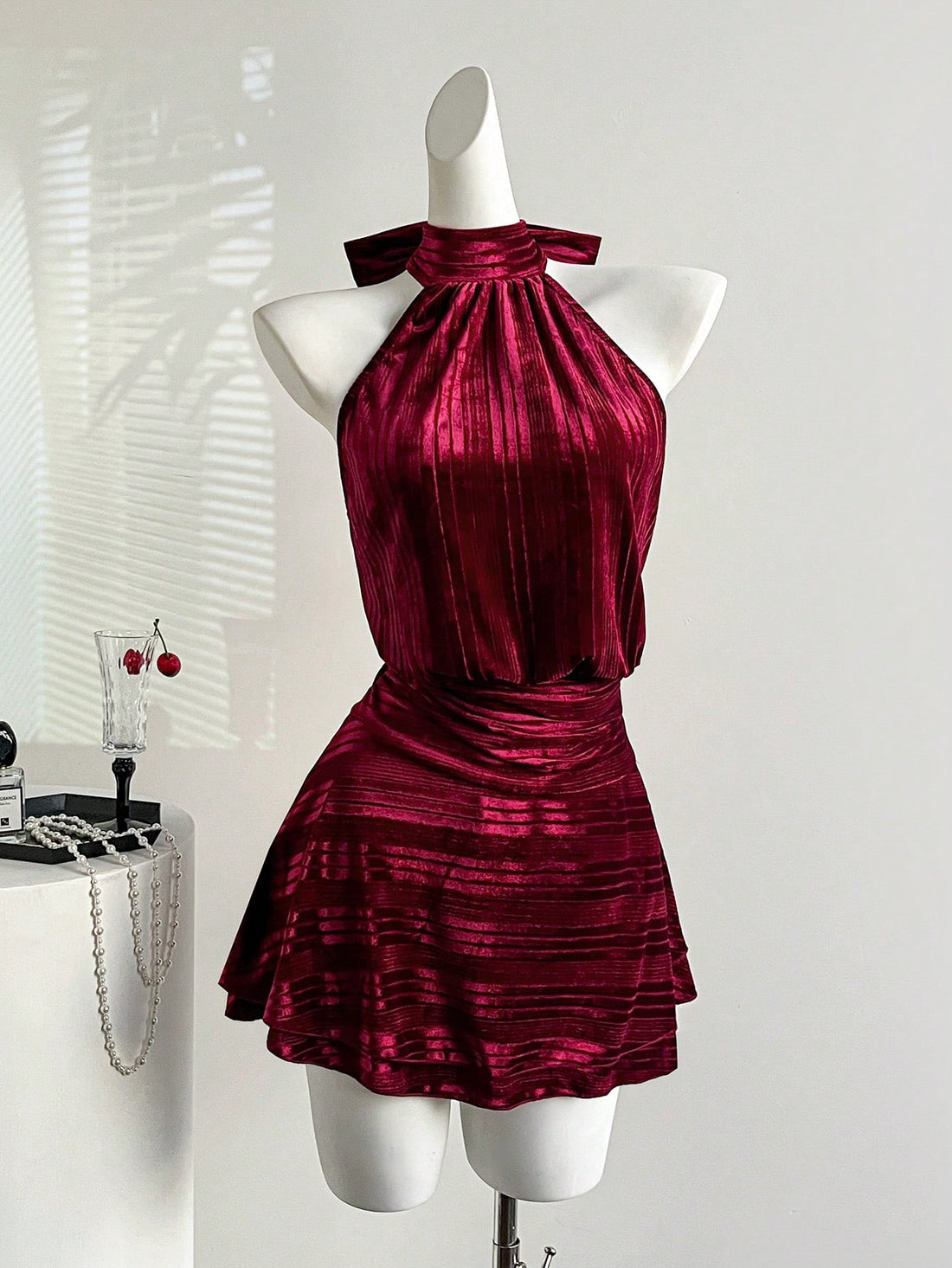 Step into the spotlight this holiday season in our stunning burgundy velvet halter dress. The luxurious velvet fabric drapes beautifully, while the flattering halter neckline frames your shoulders with elegance. Layered skirt details add movement and dimension, creating a show-stopping silhouette perfect for Christmas parties and New Year's Eve celebrations. Whether you're dancing the night away or making a grand entrance, this dress delivers sophistication with a touch of festive flair. Dress it up with he