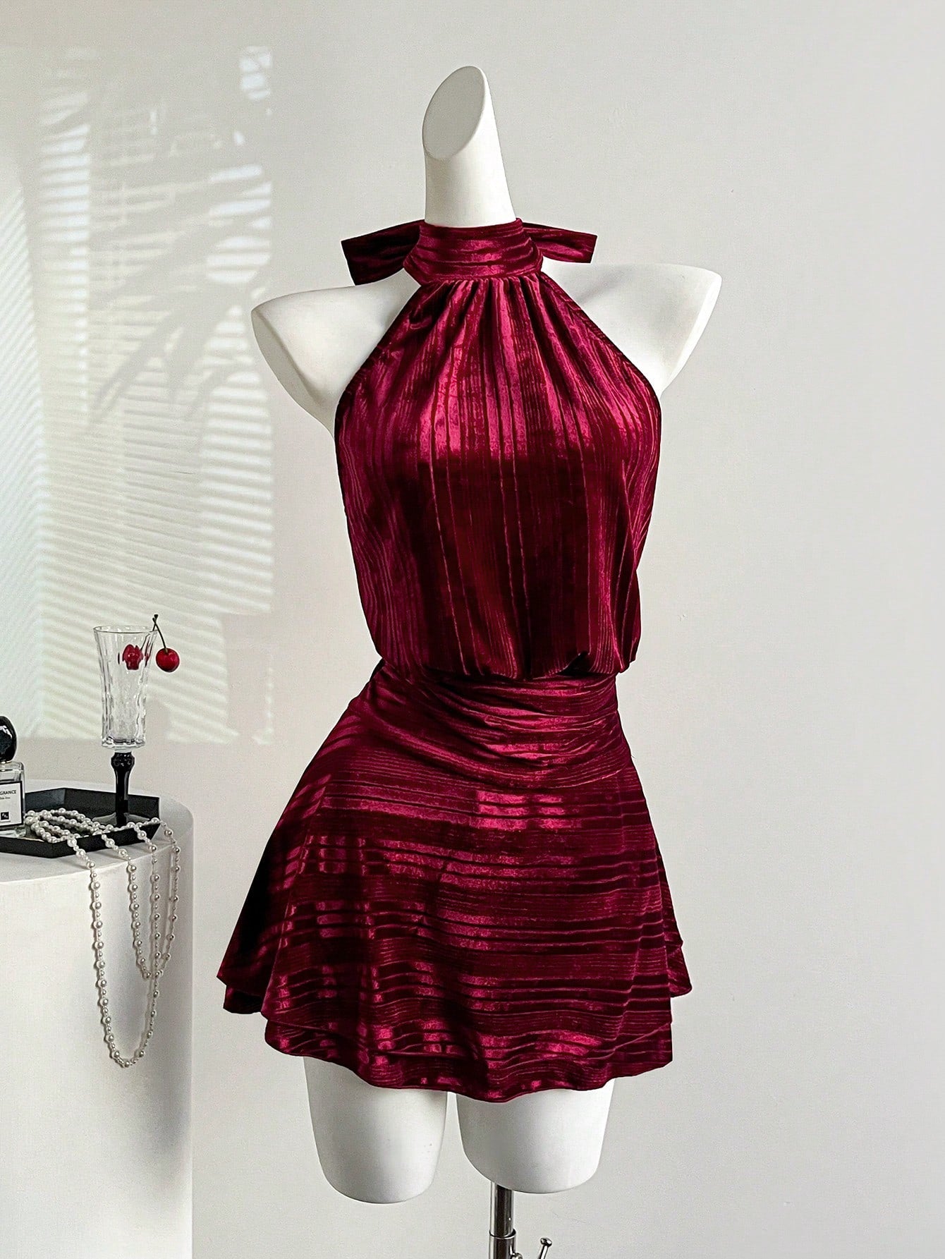 Step into the spotlight this holiday season in our stunning burgundy velvet halter dress. The luxurious velvet fabric drapes beautifully, while the flattering halter neckline frames your shoulders with elegance. Layered skirt details add movement and dimension, creating a show-stopping silhouette perfect for Christmas parties and New Year's Eve celebrations. Whether you're dancing the night away or making a grand entrance, this dress delivers sophistication with a touch of festive flair. Dress it up with he