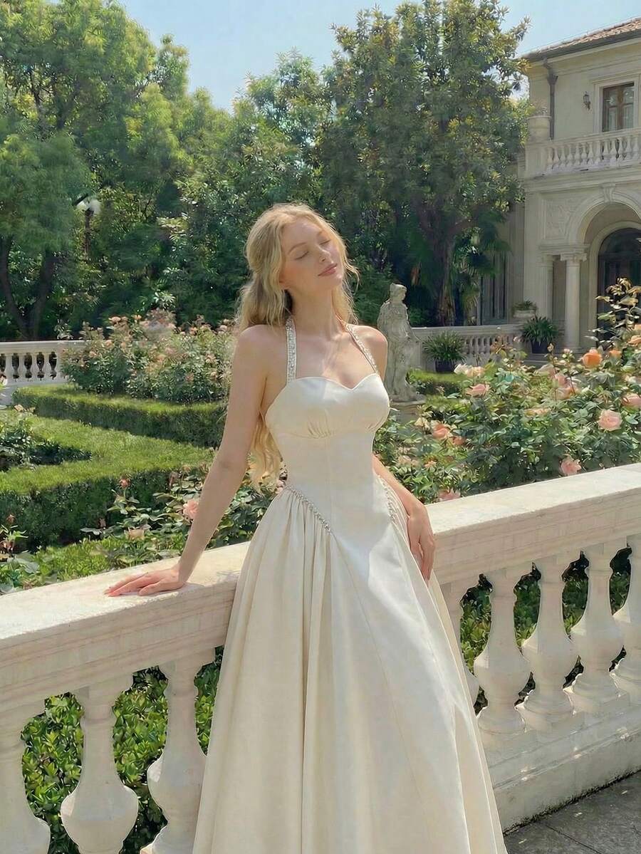 Ivory halter fit-and-flare midi dress with sweetheart bust and gathered skirt